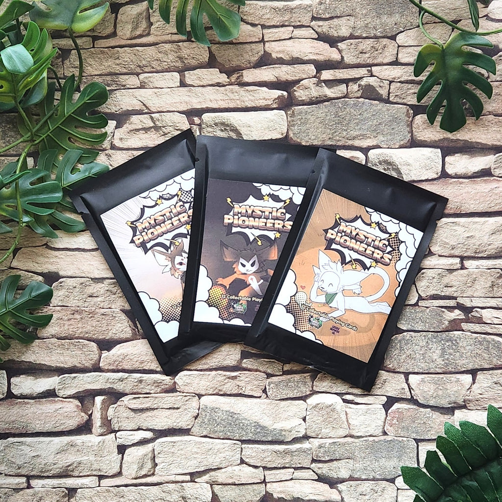 Three black stand-up pouches of Trading cards cards arranged in a fan shape on a rustic stone wall background with green plant leaves.
